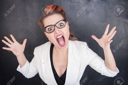 Angry screaming woman on the chalkboard background